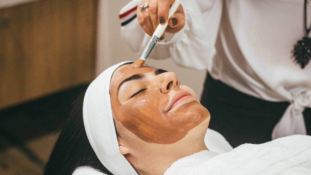 Woman receiving dermal filler injection at luxury aesthetics clinic
